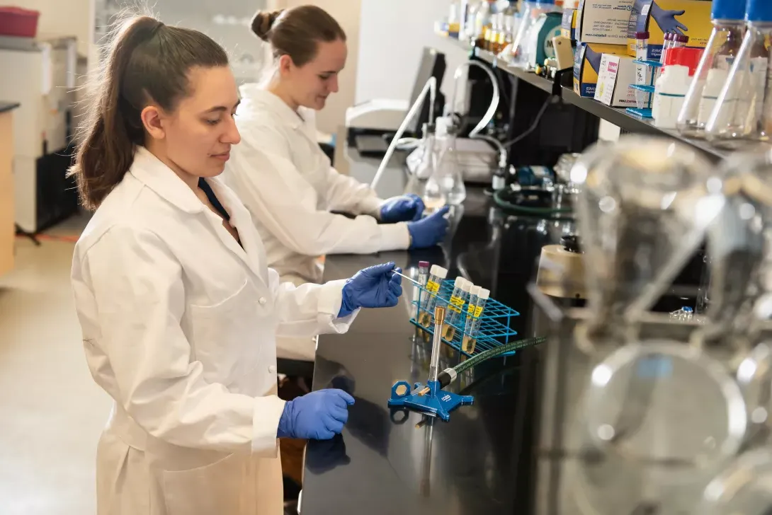 Students preparing test tubes in microbiology lab